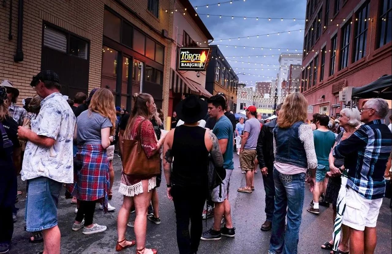 Crowd walking through Buckham Alley during an event near Torch Bar