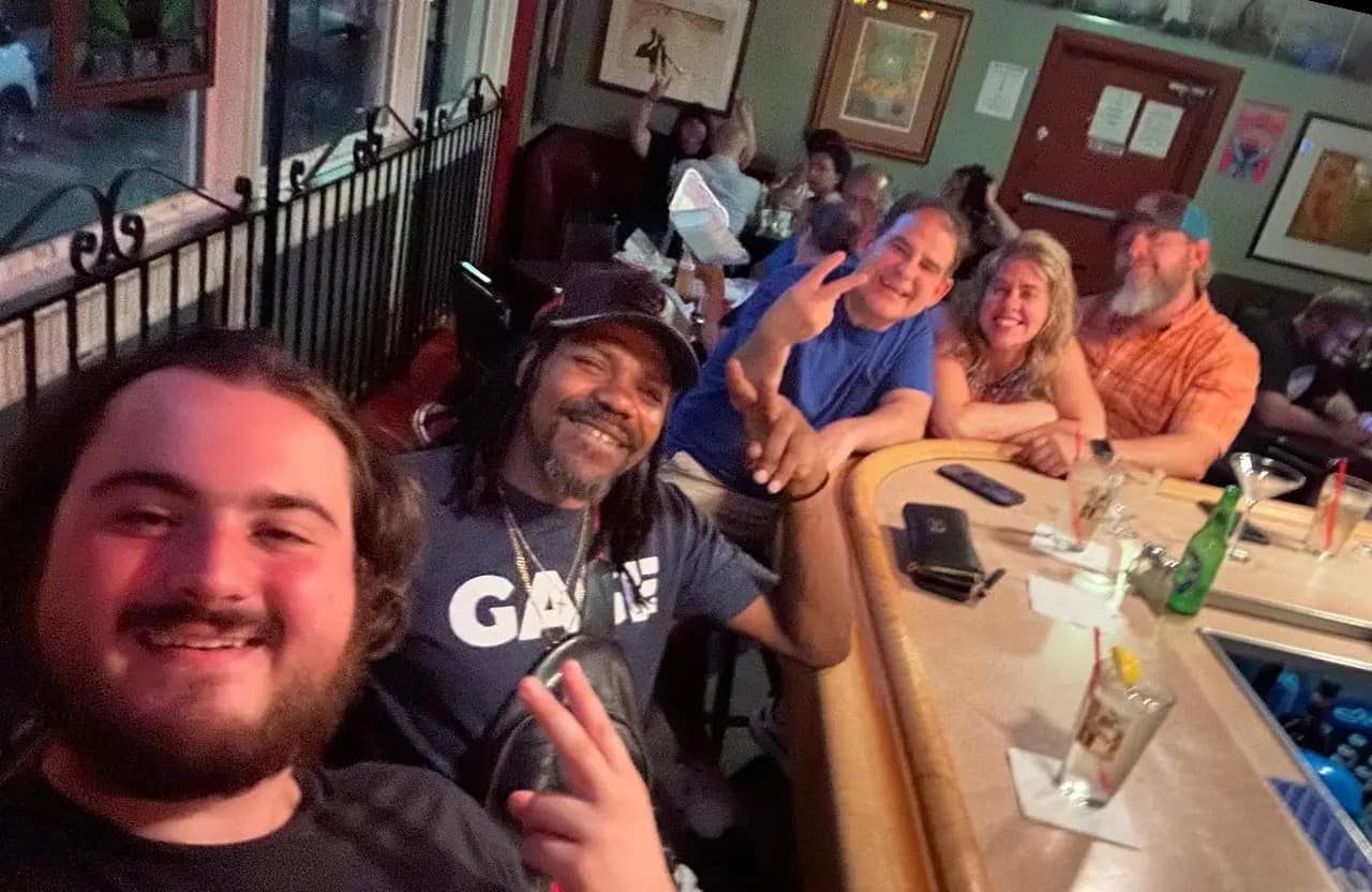 Group of friends enjoying food and drinks inside Torch Bar