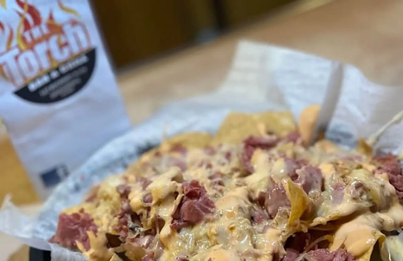 Loaded fries or nachos topped with cheese and bacon at Torch