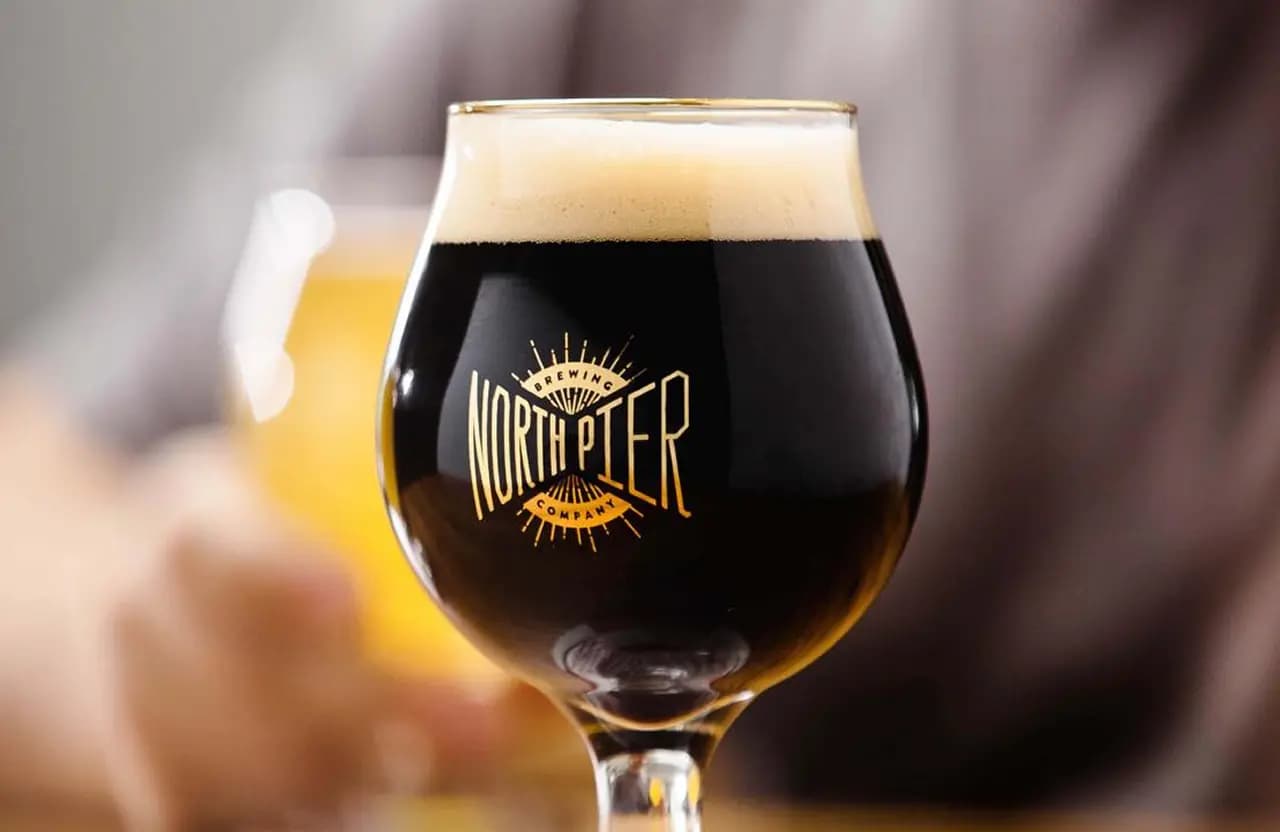 Craft beer in a branded glass at Torch Bar & Grill